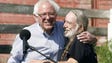 Sanders, left, is hugged by musician Willie Nelson