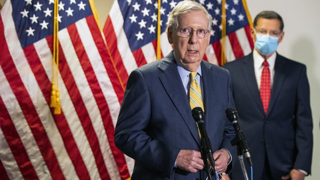 Senate Majority Leader Mitch McConnell, R-Ky., with Sen. John Barrasso, R-Wyo., speaks to reporters following a GOP policy meeting on Capitol Hill, Tuesday, June 30, 2020, in Washington.