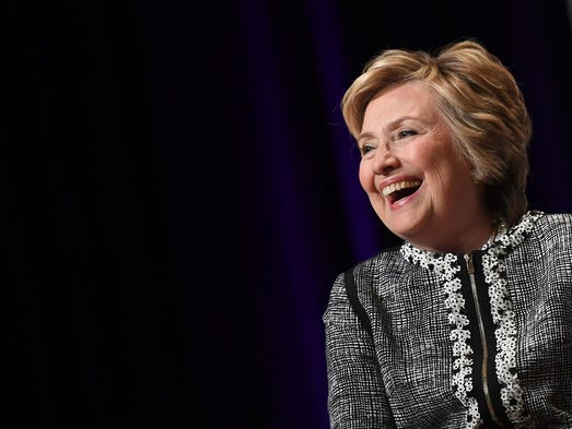 Clinton laughs onstage with novelist Cheryl Strayed