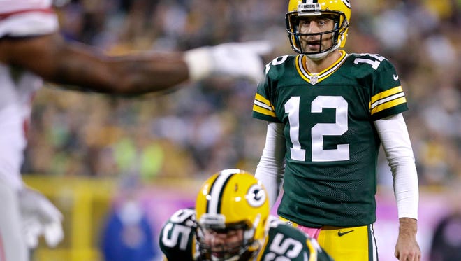 Green Bay Packers quarterback Aaron Rodgers (12) reads the defense before snapping the ball during a 23-16 win over the New York Giants NFL football game at Lambeau Field in Green Bay, WI, Sunday, October 9, 2016.