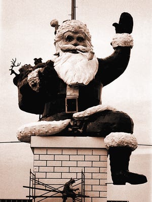 "Santa's little helper" puts on the finishing touches on Santa's chimney at the Garden State Plaza, Paramus, November 15, 1974