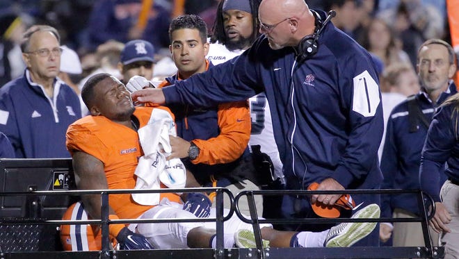 UTEP head coach Sean Kugler comforts running back LaQuintus Dowell after he suffered a serious injury Friday night against Rice, his second injury of the season. 