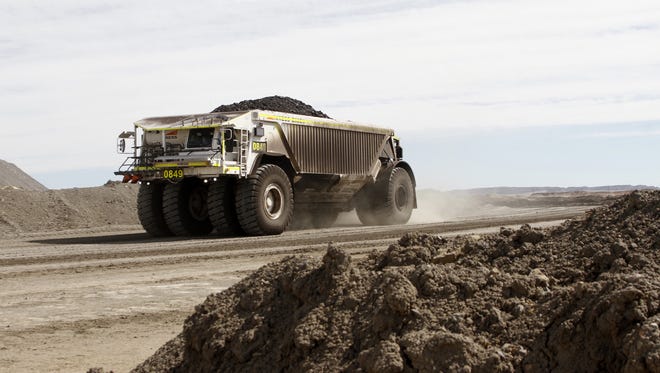 A vehicle transports coal on Oct. 9, 2013 at Navajo Mine in Fruitland. The Navajo Transitional Energy Company, which owns the mine, was recently awarded $147,900 under the Partnership for Opportunity and Workforce and Economic Revitalization, or POWER, program.