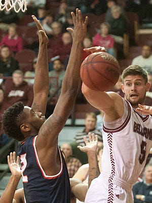 Belarmine Knights guard Rusty Troutman is trapped behind the basket and has to pass off as he is pressured by Saginaw Valley State Cardinals forward C.J. Turnage. 13 November 2015