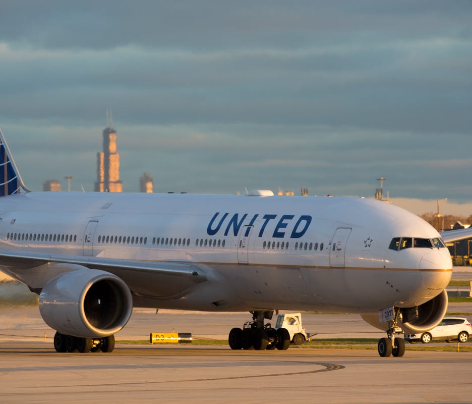 A United Airlines Boeing 777-200 taxis for departure from Chicago O'Hare International Airport in November 2016.