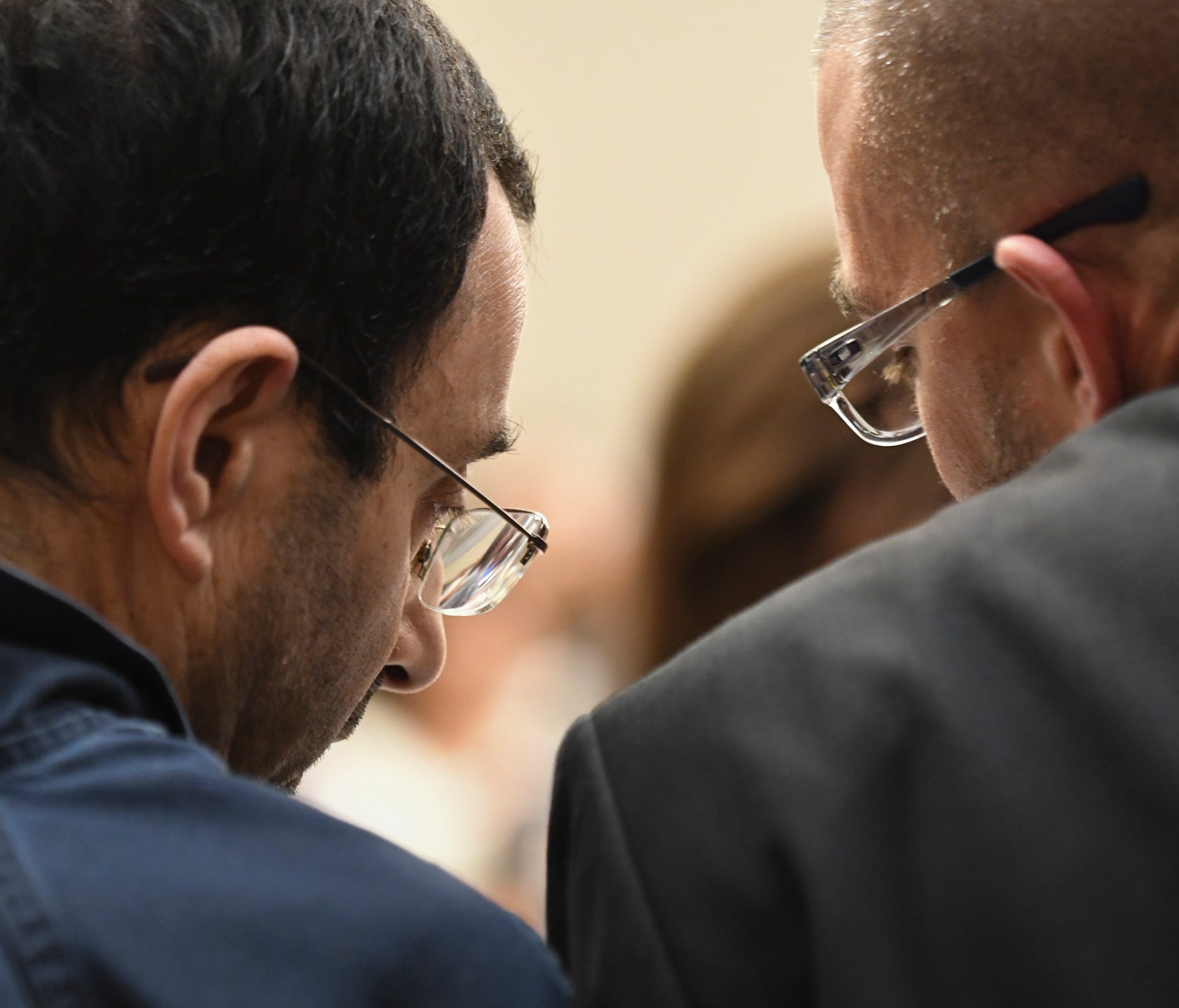 Larry Nassar talks with his attorney Matt Newburg Thursday, Jan. 18, 2018, in Circuit Judge Rosemarie Aquilina's courtroom during the third day of victim impact statements regarding former sports medicine doctor, who pled guilty to seven counts of se