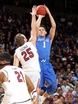 Kentucky guard Devin Booker (1) shoots a jump shot over South Carolina's Mindaugas Kacinas (25) in the first half of an NCAA college basketball game, Saturday, Jan. 24, 2015, at the Colonial Life Arena in Columbia, S.C. (AP Photo/Willis Glassgow)