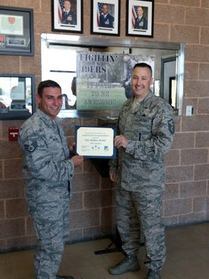Staff Sgt. Matthew Moskal, 49th Security Forces craftsman, is presented the Top III non-commissioned officer award for May from Master Sgt. Timothy Gatten, 54th AMXS first sergeant and Top III president, at Holloman Air Force Base, N.M., June 29, 2017. During the month of May, Moskal administered 14 duty position evaluations and assisted the unit training section by certifying 16 airman on radio detecting and ranging and 10 airman on taser. Moskal earned superior academic achievement while being a student at the interservice non-lethal individual weapons instructor course (INIWIC), Marine Corps detachment, Fort Leonard Wood, Missouri. Moskal was awarded the Honor Graduate at the end of INIWIC and received the Marine Corps Certificate of Commendation.