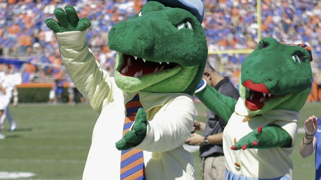 Albert and Alberta, the mascots for Florida, do the gator chomp before a football game in Gainesville, Fla. Florida is ending its 'gator bait' cheer at football games and other sports events because of its racial connotations, the school's president announced last month.