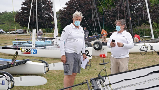 Rick Bliss and Mike Levesque, the principal race officer for New England 100 regatta, prepare for the race on Saturday. Bliss was a close friend of Sandra Tartaglino, who died in this event a year ago when a powerboat collided with her catamaran.
