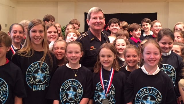 Sheriff Prator poses with First Baptist students at a recent DARE graduation