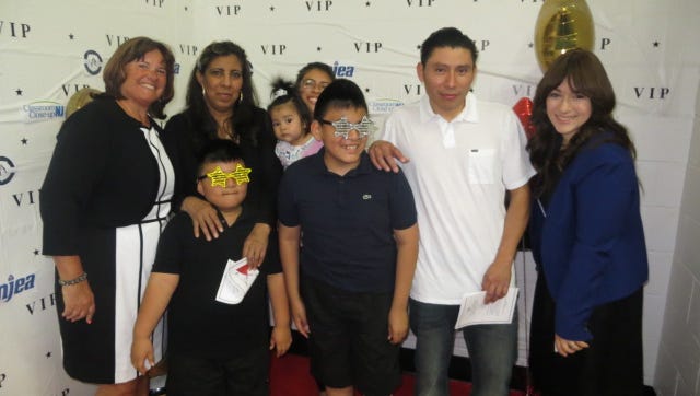 Zahava Friedman, occupational therapist and Maureen Casey, speech therapist, pose at the Red carpet along with Erick Suchite, Friends Club member, and his family