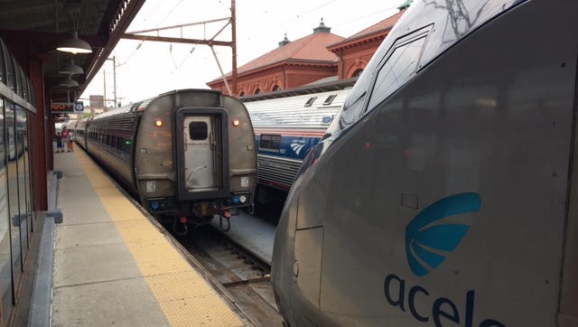 Amtrak trains backed up at the Wilmington train station after train service was ceased Friday as police in Pennsylvania investigated an officer being shot near Philadelphia.