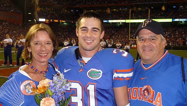 Gulf Coast graduate Brian Biada (31) poses with parents Jeanne and Gregg during Senior Night for the University of Florida football team in November 2011. Biada spent three seasons as a walk-on player with the Gators.