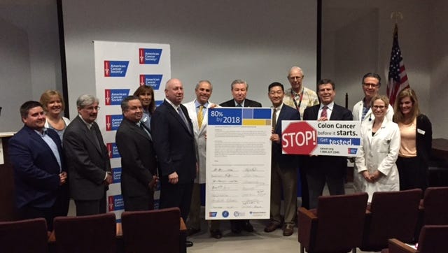 Hunterdon Medical Center and the American Cancer Society took positive steps toward encouraging colorectal cancer screenings Wednesday. Pictured are Dr. Alvaro Carrascal, (left of poster being held), Dr. Jeffrey Hartford (left center), Dr. Kenneth Blankstein (center in white coat) and Robert P. Wise (center in dark suit holding poster).