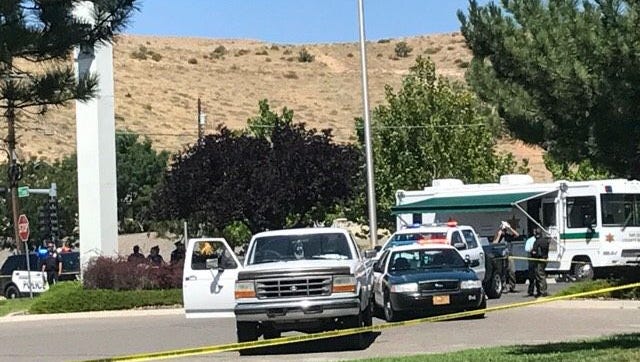 Officers from various law enforcement agencies gather in the parking lot of the Citizens Bank location on Hudson Street in Farmington Aug. 27 after the shooting of a State Police officer.