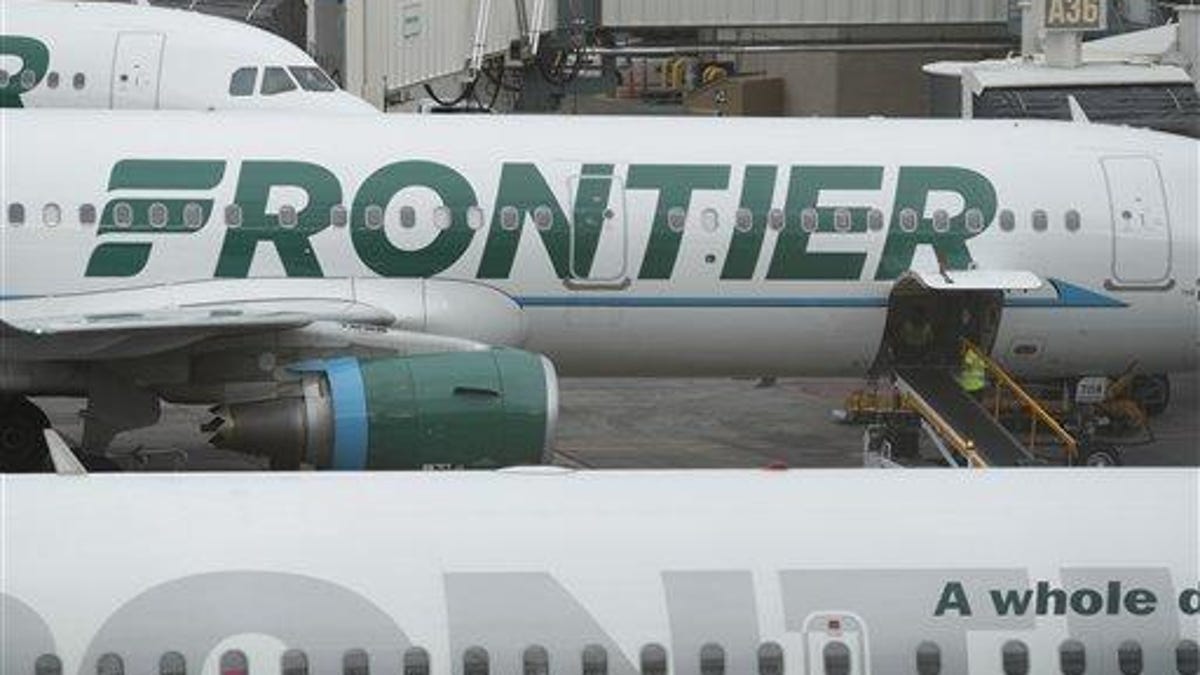 A Frontier Airlines airplane waiting at a gate at Denver International Airport.