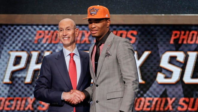North Carolina State's T.J. Warren, right, poses for a photo with NBA Commissioner Adam Silver after being selected 14th overall by the Phoenix Suns during the 2014 NBA draft, Thursday, June 26, 2014, in New York.