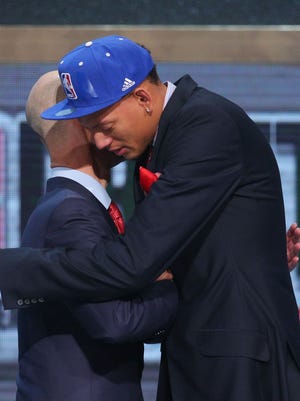 Isaiah Austin hugs NBA Commissioner Adam Silver after being an honorary draftee Thursday.