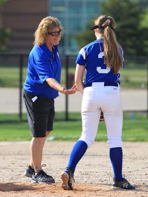 Veteran Salem varsity softball coach Bonnie Southerland congratulates pitcher Maddy Rosiewicz (3) for a job well done. Southerland recently earned her 500th victory at the Salem helm.
