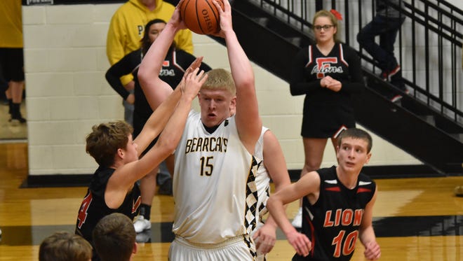 Paint Valley's Dylan Swingle fights his way past a defender before scoring Wednesday night against Leesburg Fairfield. Swingle and the Bearcats knocked off the Lions, 59-55, winning their fifth straight.