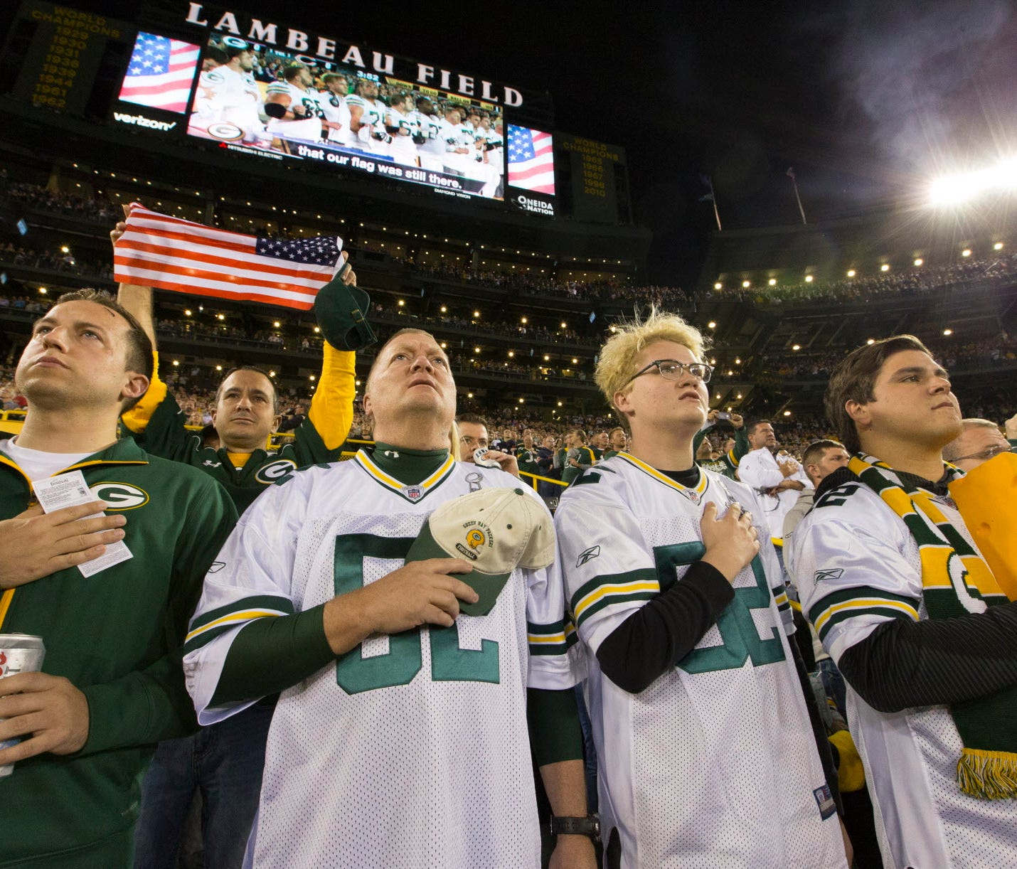 Scott Sheffield (second from left) and his sons, Connor and Spencer, stand for the national anthem before the Green Bay Packers game against the Chicago Bears  on Thursday at Lambeau Field in Green Bay. The family from St. George, Utah, said they wer