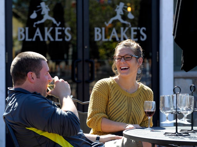 Payton Kaminski shares a laugh with her boyfriend, Mike Simpson, both of Oxford, as he drink Flannel Mouth Hard Cider and she drinks Blue Berry Fields Wine. Patrons gather at Blakes's Hard Cider Co., in Armada Township Wednesday afternoon, Sept.24, 2014, as hard cider continues to gain popularity across the United States.