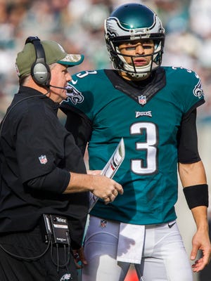 Eagles quarterback Mark Sanchez talks with head coach Chip Kelly during a stoppage in play in the first quarter of an NFL football game at Lincoln Financial Field in Philadelphia, Pa. on Sunday afternoon, November 23, 2014.