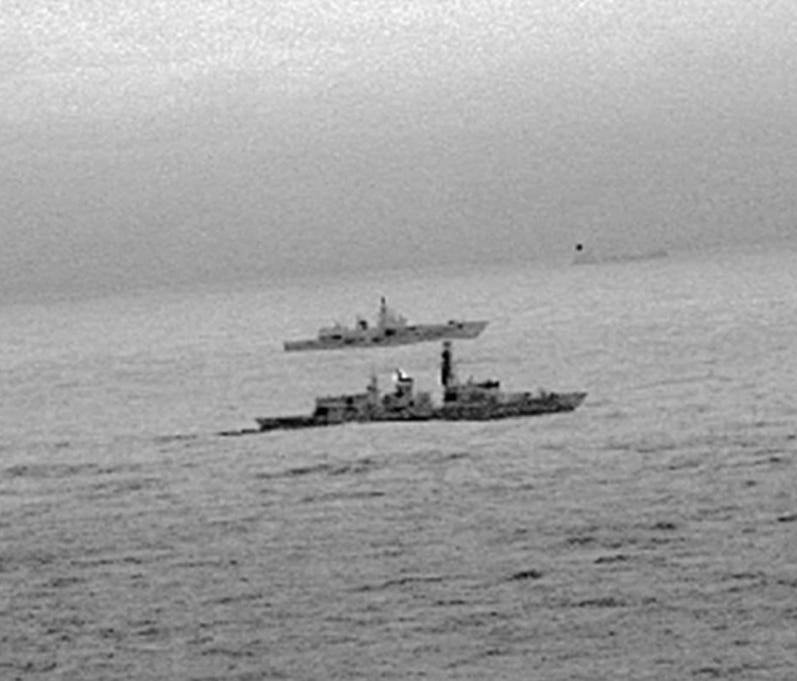 A handout photo made available by the British Ministry of Defence (MOD) on Dec. 26 shows Britain's Royal Navy frigate HMS St Albans escorting a Russian warship through the North Sea and areas of British interest on Christmas Day.