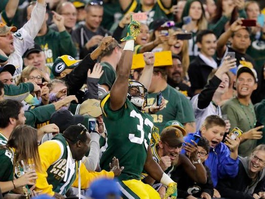 Green Bay Packers' Aaron Jones (33) celebrates a second