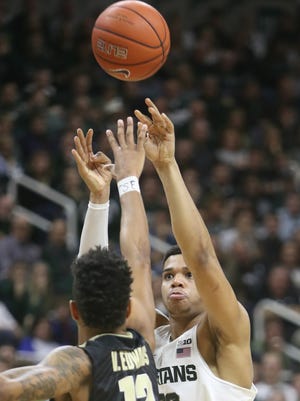 Michigan State forward Miles Bridges scores against Purdue forward Vincent Edwards during the second half of MSU's 84-73 loss Tuesday at Breslin Center.