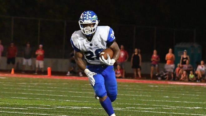Miyan Williams dishes for a touchdown late in the 4th quarter to put Winton Woods up 18-7 at LaSalle Friday, September 22nd at LaSalle High School