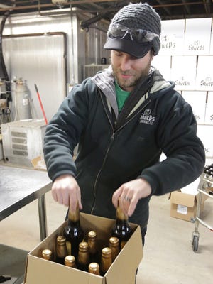 Alex Butterbaugh of 3 Sheeps Brewing Company packages beer at the Sheboygan brewery.
