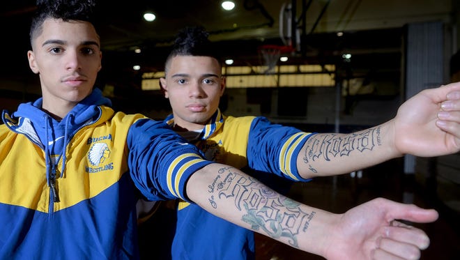 Brothers and Buena wrestlers Junior LaPortez, 17, and Chris LaPortez, 16 (from left), display matching tattoos, which honor their mother Rosa, who died in December.