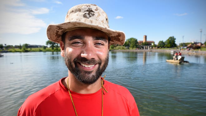 Jose Rivera smiles while working Wednesday, June 29, 2016, at the boat landing on Lake George. Rivera is a Campus Recreation intern at St. Cloud State University.