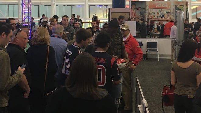 Bengals safety George Iloka signs autographs while working his way through Radio Row at Super Bowl LI in Houston.