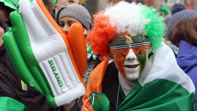 A spectator is dressed in a costume featuring the national colours of the Republic of Ireland as he watches the St Patrick's Day parade in Dublin on March 17, 2015. AFP PHOTO / PAUL FAITHPAUL FAITH/AFP/Getty Images ORG XMIT: 3984 ORIG FILE ID: 538926994