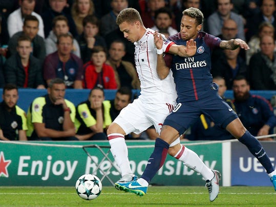 Bayern's Joshua Kimmich, left, and PSG's Neymar challenge for the ball during the Champions League soccer match between Paris Saint Germain and Bayern Munich in Paris, France, Wednesday, Sept. 27, 2017. (AP Photo/Thibault Camus)