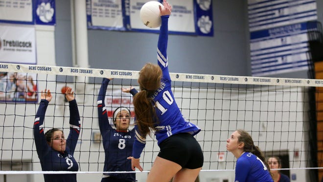 Barron Collier's Shey Kirwin hits the ball during the Class 7A regional quarterfinal between the Cougars and Estero at Barron Collier High School on Wednesday, Oct. 25, 2017. 