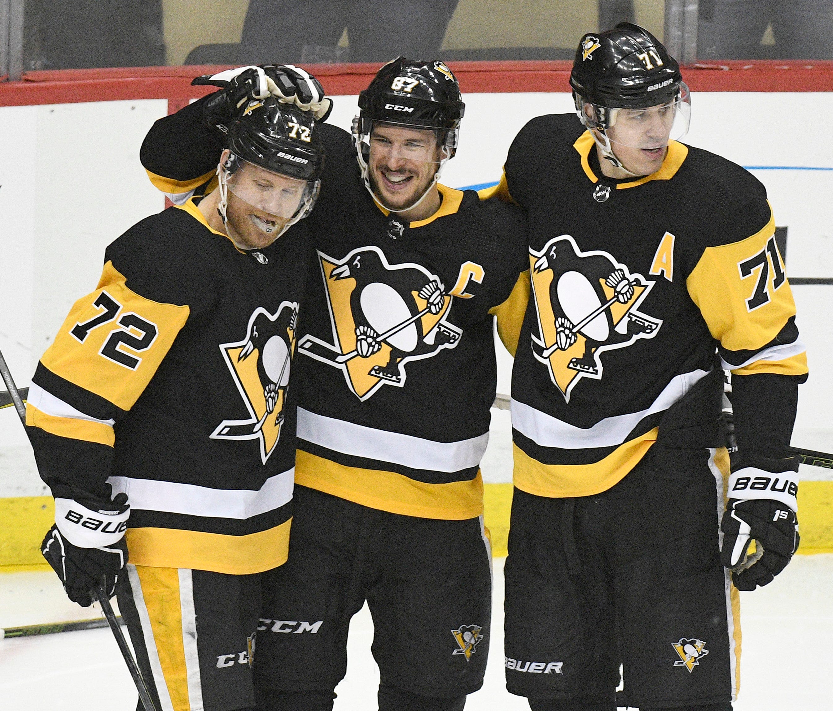 Pittsburgh Penguins right wing Patric Hornqvist (left) Sidney Crosby (center) and Evgeni Malkin (right) celebrate after Crosby scored a goal against the Ottawa Senators in the second period of an NHL game at PPG PAINTS Arena.