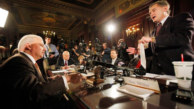 Wisconsin Senate Majority Leader Scott Fitzgerald (R-Juneau) bangs the gavel over the protests of then-Assembly Minority Leader Peter Barca, right, during a hastily called conference committee meeting at which Republicans voted to send Gov. Scott Walker's controversial budget repair bill back to the two chambers of the Legislature. The bill, later known as Act 10, was among the one out of every four bills that was fast-tracked in Walker’s first two years in office, a Wisconsin Center for Investigative Journalism analysis showed.