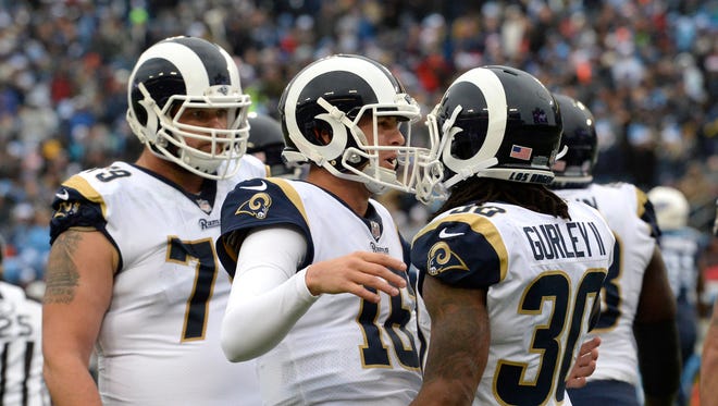 Los Angeles Rams running back Todd Gurley (30) celebrates with quarterback Jared Goff (16) after Gurley scored a touchdown on an 11-yard pass reception against the Tennessee Titans in the first half Sunday.