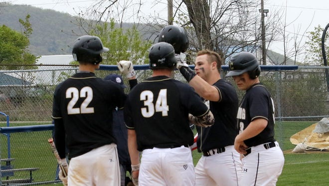 Trevor Henneman, third from left, is congratulated by teammates after hitting a three-run homer Friday in Corning's 7-6 win over Horseheads at Horseheads High School.