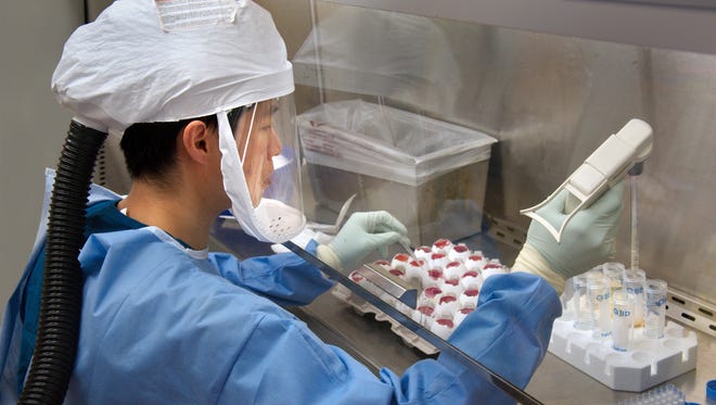 A CDC Scientist harvests H7N9 virus that has been grown for sharing with partner laboratories for research purposes.