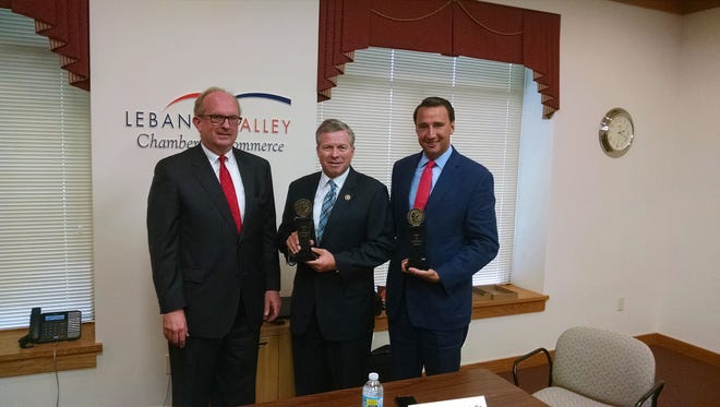 Jack Howard, left, of the U.S. Chamber of Commerce, presents Congressman Charlie Dent, center, and Congressman Ryan Costello with the 'Spirit of Enterprise Award' for their support of American business on Thursday at the Lebanon Valley Chamber of Commerce where they both spoke and took questions at the Chamber’s Public Affairs Roundtable event. Both congressmen represent part of Lebanon County.