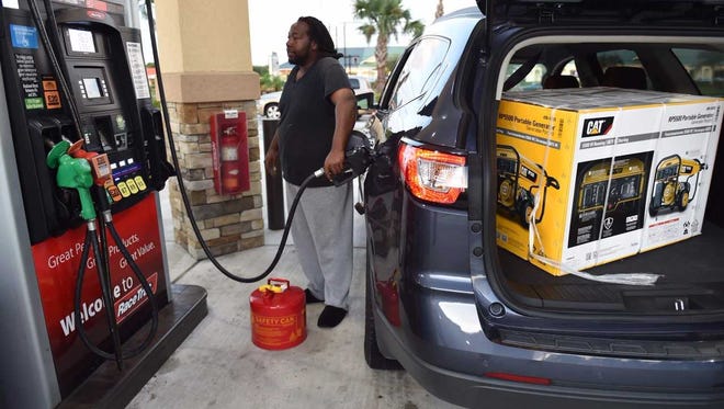 William Butts Jr. of Fort Pierce, fuels up at the Race Trac gas station along U.S. 1 at Savannah Club Boulevard on Sept. 8, 2017 in Port St. Lucie ahead of Hurricane Irma. He bought a generator at the Lowe's in Jensen Beach.