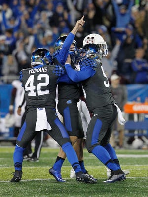 Oct 22, 2016; Lexington, KY, USA; Kentucky Wildcats kicker Austin MacGinnis (99) celebrates with teammates after kicking the game winning field goal against the Mississippi State Bulldogs in the second half at Commonwealth Stadium. Kentucky defeated Mississippi 40-38.