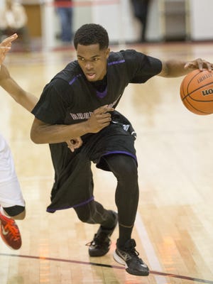K.J. Walton (right), of Brownsburg High School, drives on Jalen White of Pike, during boys basketball at Pike High School, Indianapolis, Saturday, Jan. 3, 2015.
