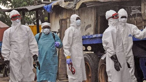 Liberian health workers are shown outside a home of a man that they believed died from the Ebola virus in Monrovia, Liberia, Friday, Aug. 29, 2014. The Ebola outbreak in West Africa eventually could exceed 20,000 cases, more than six times as many as are now known, the World Health Organization said Thursday. A new plan released by the U.N. health agency to stop Ebola also assumes that the actual number of cases in many hard-hit areas may be two to four times higher than currently reported.