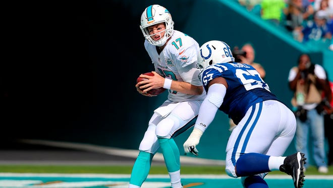 Miami Dolphins quarterback Ryan Tannehill (17) is sacked by Indianapolis Colts defensive tackle T.Y. McGill (67) for a safety during the first half at Sun Life Stadium.